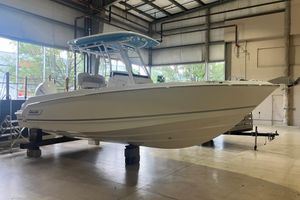 Boston Whaler 230 Outrage 2026 Boston Whaler 230 Outrage boat displayed in a spacious indoor showroom.