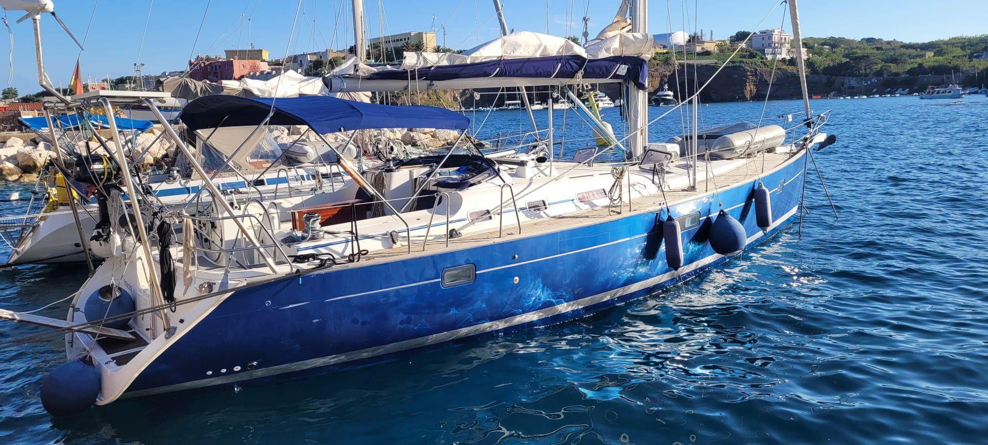 Beneteau Oceanis 473 2005 Beneteau Oceanis 473 sailboat docked in a sunny marina, featuring a sleek blue hull.