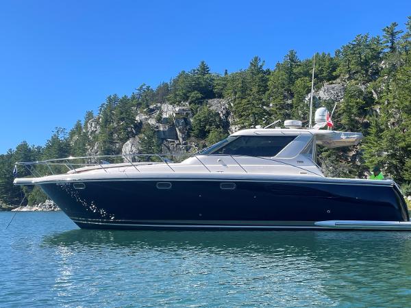 Tiara Yachts 4400 Sovran 2005 Tiara Yachts 4400 Sovran in scenic waters, surrounded by lush greenery and rocky cliffs.