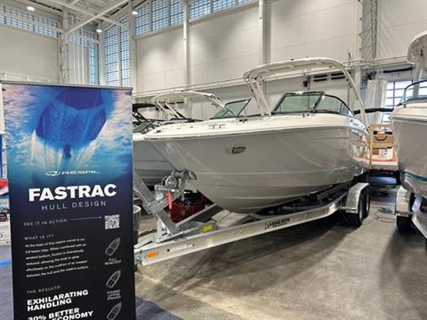 Regal LX4 2024 Regal LX4 boat with FasTrac hull design on display in a showroom.