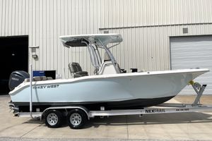 Key West 239 FS 2024 Key West 239 FS boat on trailer, parked outside a warehouse.