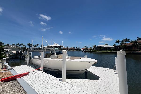 Pursuit S 288 Sport 2020 Pursuit S 288 Sport boat docked at a sunny marina.