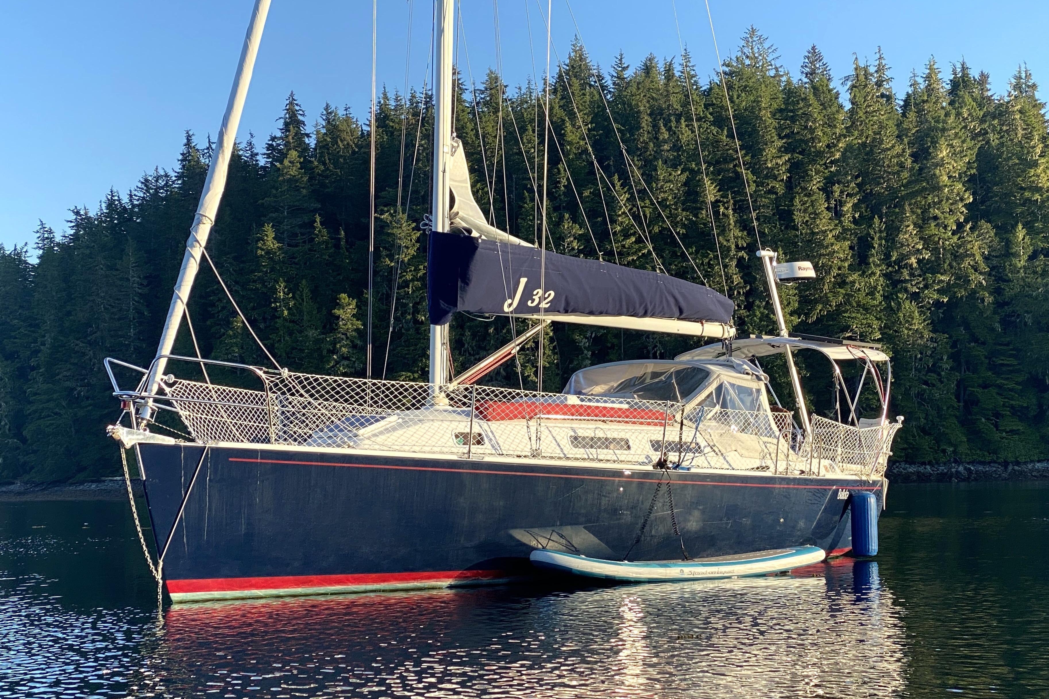 J Boats J/32 1998 J Boats J/32 sailboat anchored in serene forested waters.