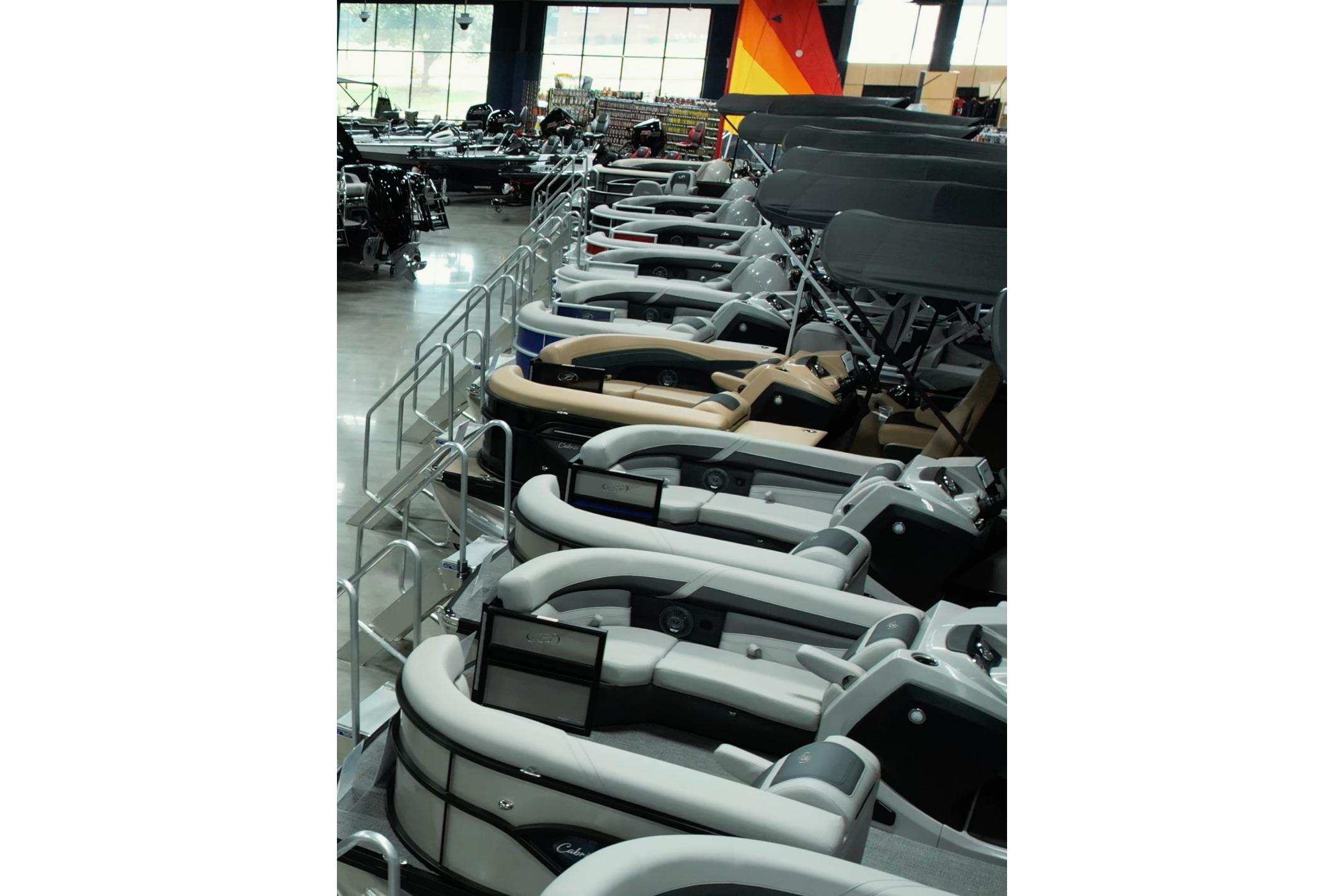 Barletta Cabrio 24UE Row of 2026 Barletta Cabrio 24UE boats in showroom display.