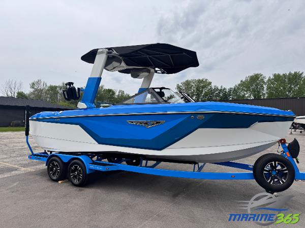 Nautique Super Air Nautique S23 2025 Nautique Super Air Nautique S23 boat on trailer, blue and white design, parked outdoors.