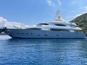CRN 129 Luxurious 2009 CRN 129 yacht on serene blue waters, under a clear sky.