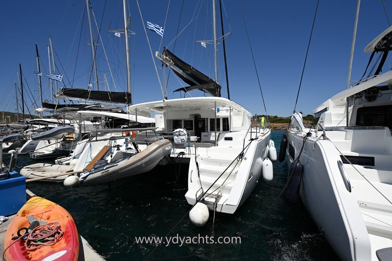 Lagoon 450 F 2019 Lagoon 450 F catamaran docked at marina with kayaks and dinghies.