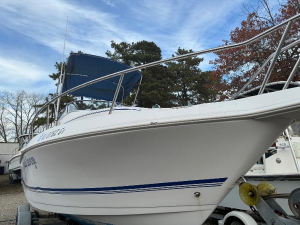 Pro-Line 23 Walk 2006 Pro-Line 23 Walk boat on trailer with blue canopy.