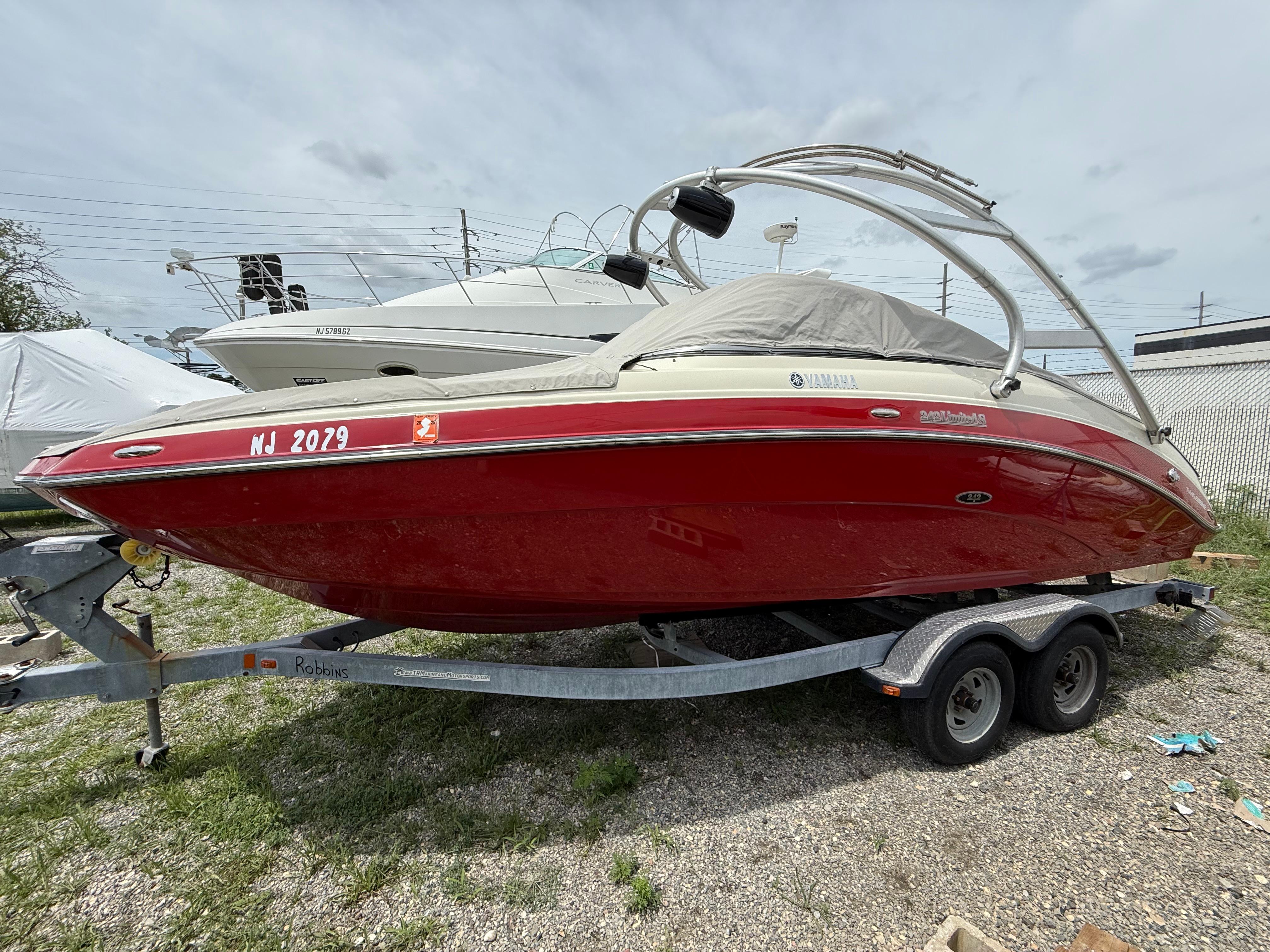 Yamaha Boats 242 Limited S 2014 Yamaha Boats 242 Limited S in red on a trailer, parked outdoors.