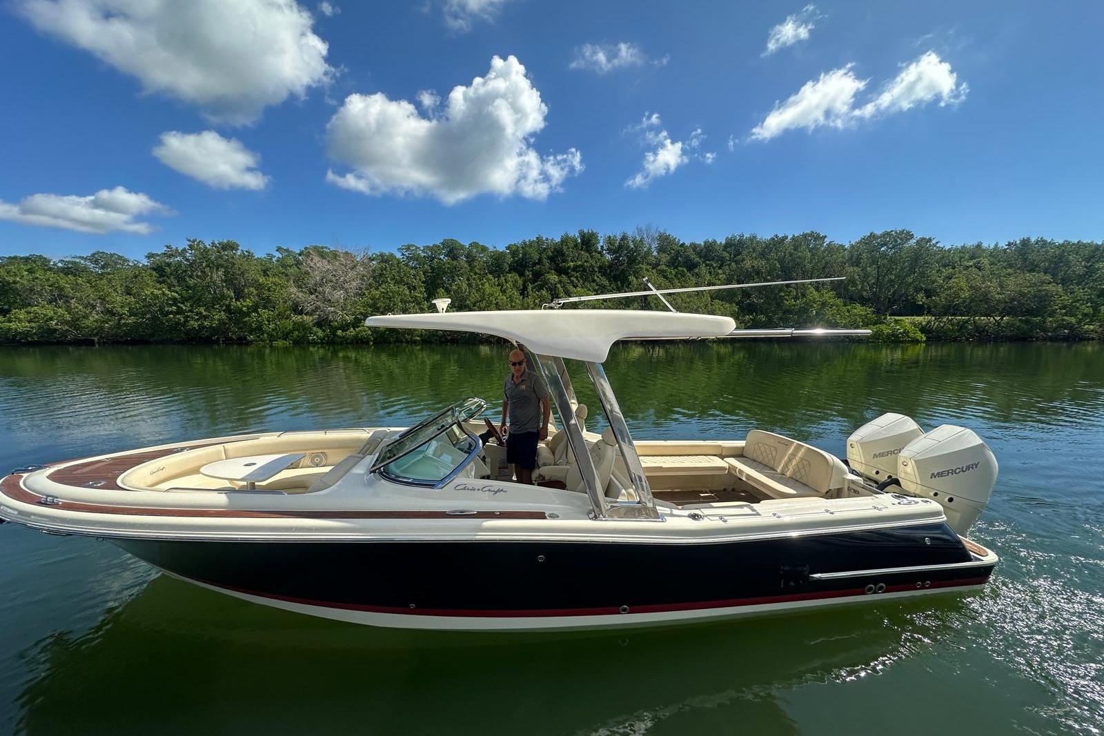 Chris-Craft Calypso 26 2019 Chris-Craft Calypso 26 boat on calm water, under a clear blue sky.