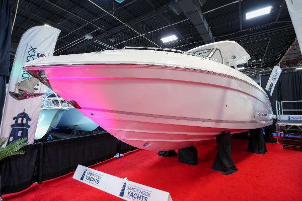 Regal 33 SAV 2025 Regal 33 SAV yacht displayed on red carpet at boat show.