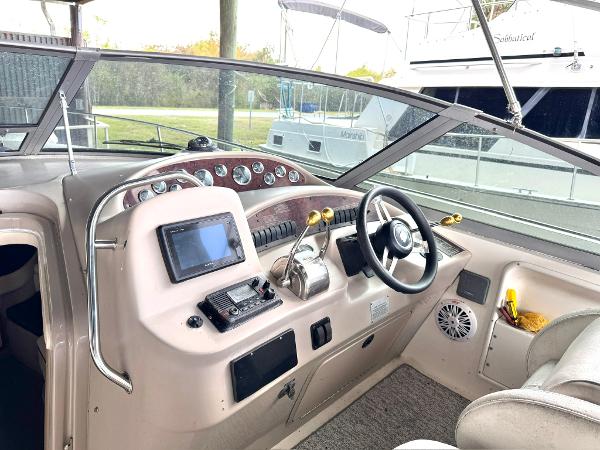 Sea Ray 340 Sundancer Cockpit of 2000 Sea Ray 340 Sundancer with steering wheel and navigation controls.