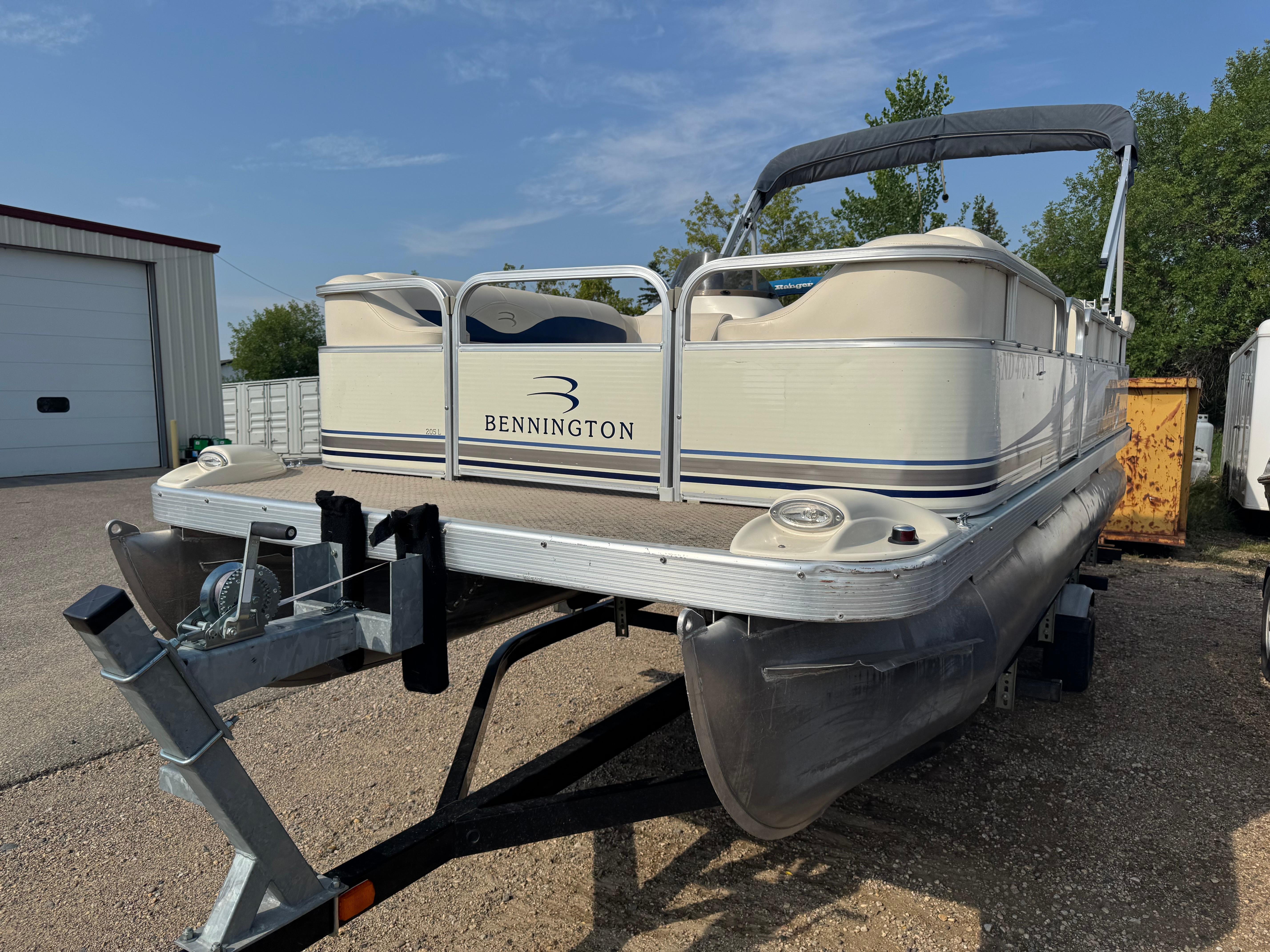 Bennington 205L 2003 Bennington 205L pontoon boat on trailer, parked outdoors.