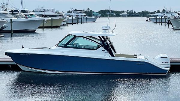 Pursuit DC 295 Dual Console 2021 Pursuit DC 295 Dual Console boat docked in a marina.