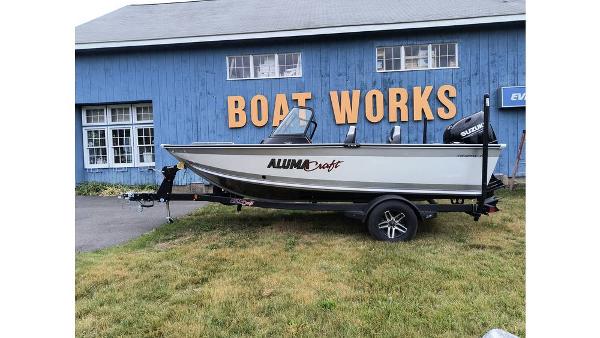 Alumacraft Trophy 175 2023 Alumacraft Trophy 175 boat on trailer outside Boat Works building.