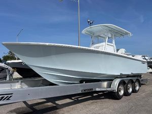 Contender 30 ST 2025 Contender 30 ST boat on a trailer, displayed outdoors under a clear blue sky.