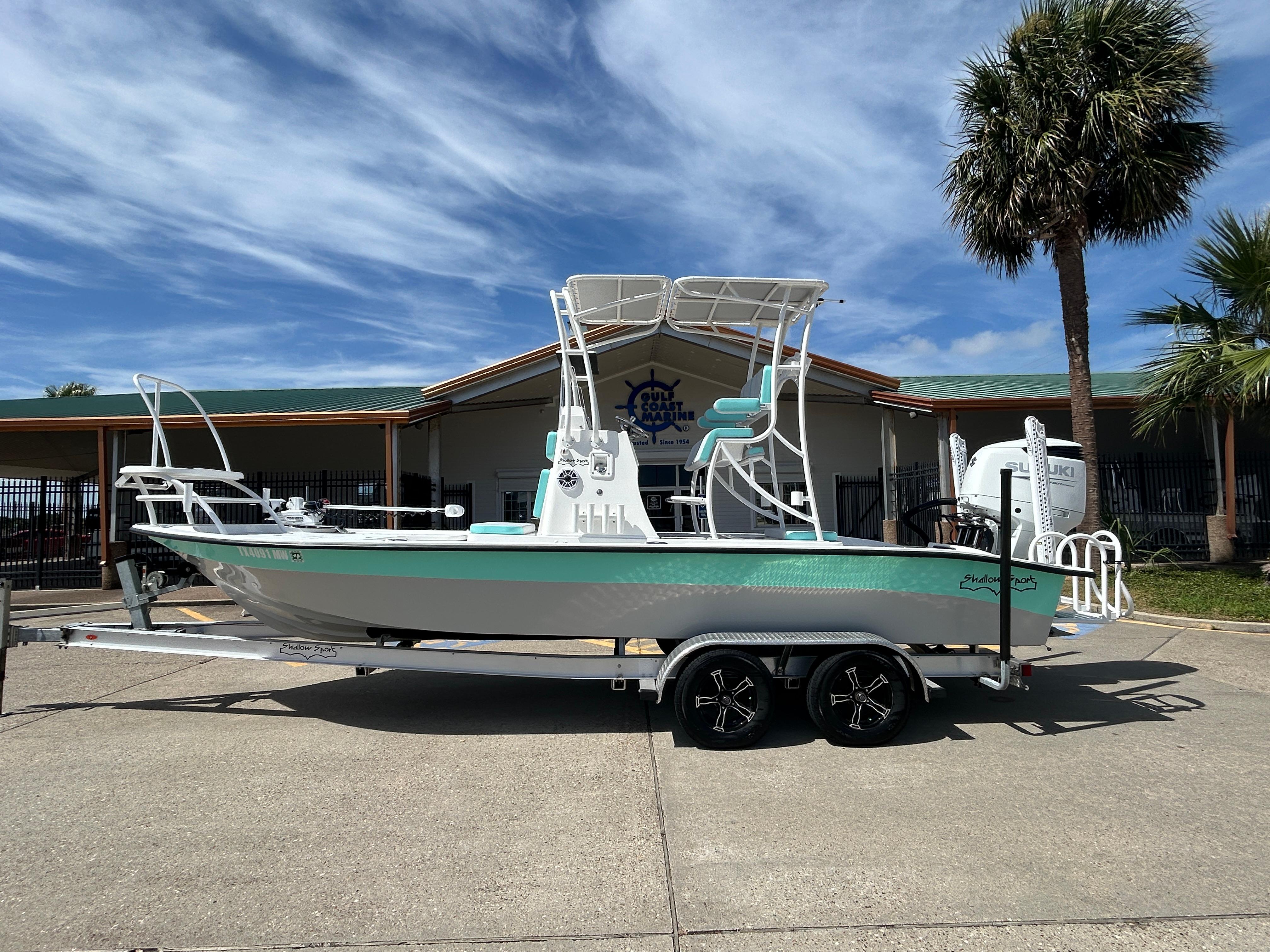 Shallow Sport 24 Modified V 2024 Shallow Sport 24 Modified V boat on trailer, parked outdoors under blue sky.