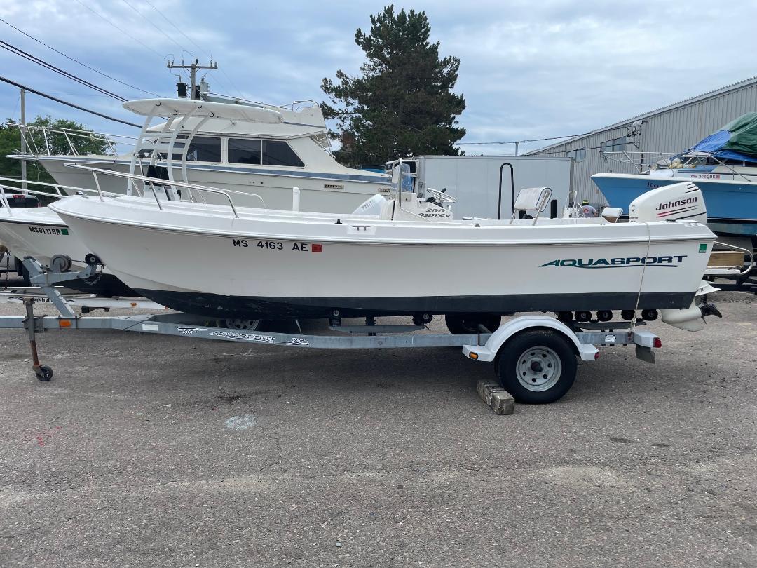 Aquasport 200 Osprey 2002 Aquasport 200 Osprey boat on trailer, parked outdoors.