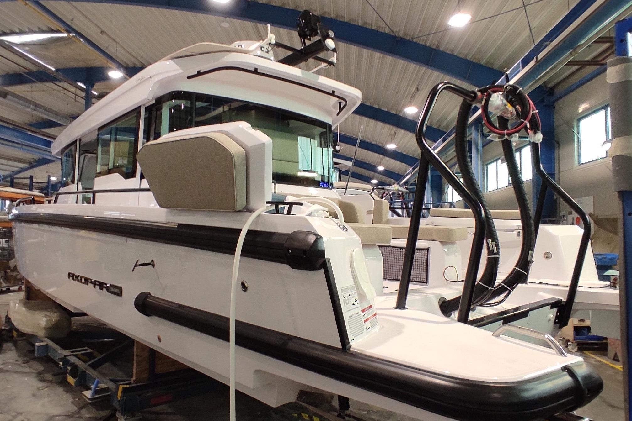 Axopar 37 Cross Cabin 2025 Axopar 37 Cross Cabin boat in a showroom, showcasing sleek design and modern features.