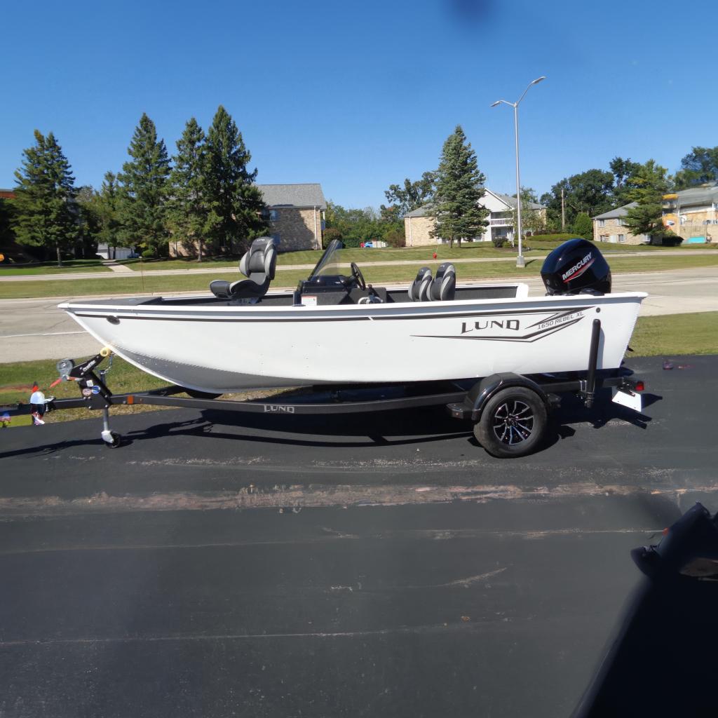 Lund 1650 Rebel XL SS 2026 Lund 1650 Rebel XL SS boat on trailer, parked outdoors.