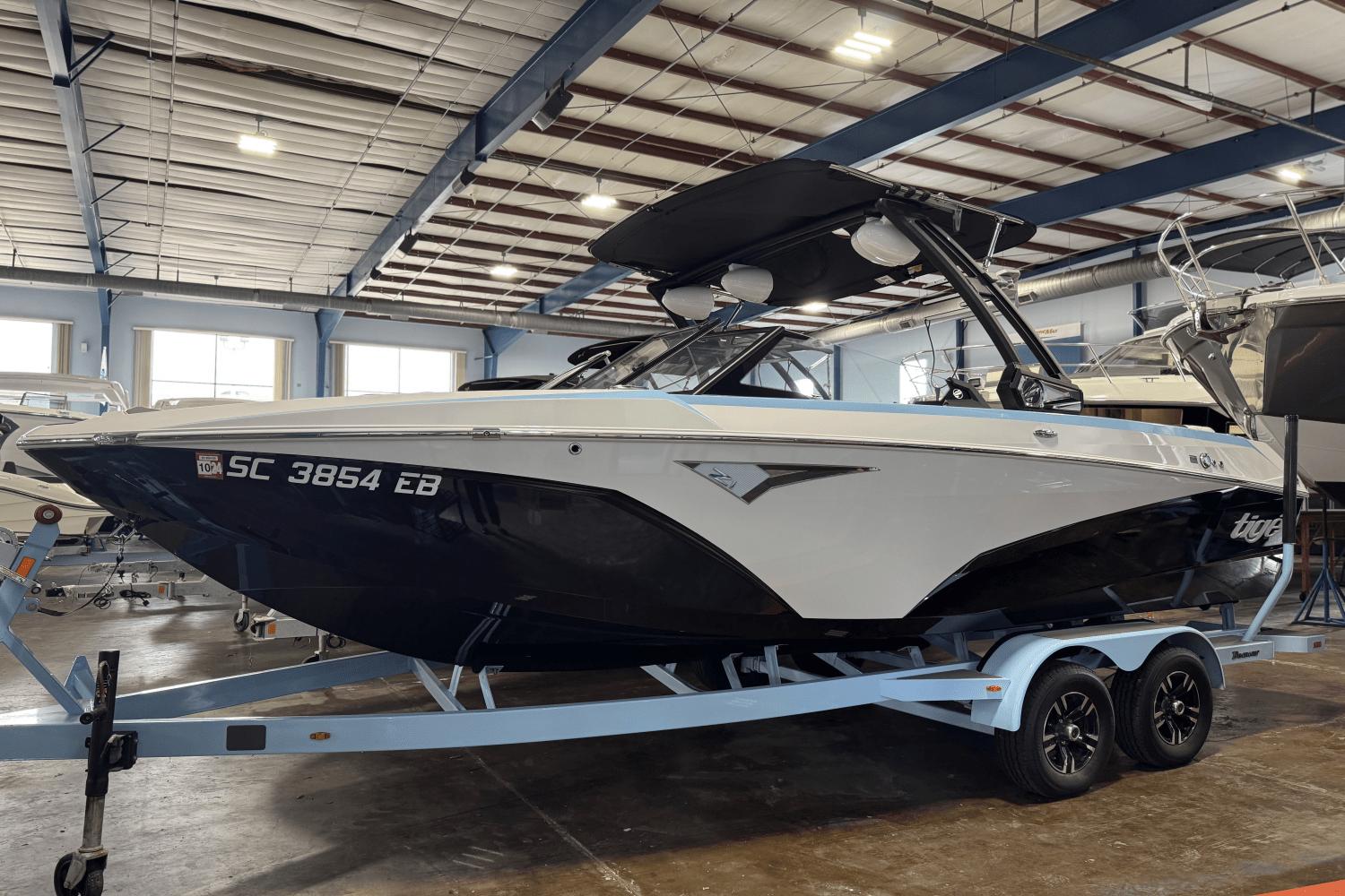 Tigé Z1 SALTWATER 2022 Tigé Z1 Saltwater boat on trailer in indoor storage facility.