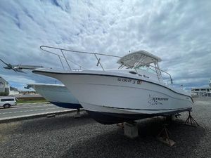 Seaswirl Striper 2601 Walkaround O/B 2003 Seaswirl Striper 2601 Walkaround O/B boat on display under cloudy sky.
