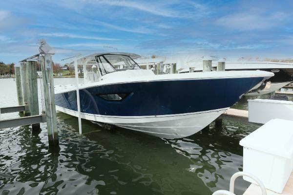 Pursuit S 378 Sport 2022 Pursuit S 378 Sport boat docked in marina, featuring sleek blue and white design.