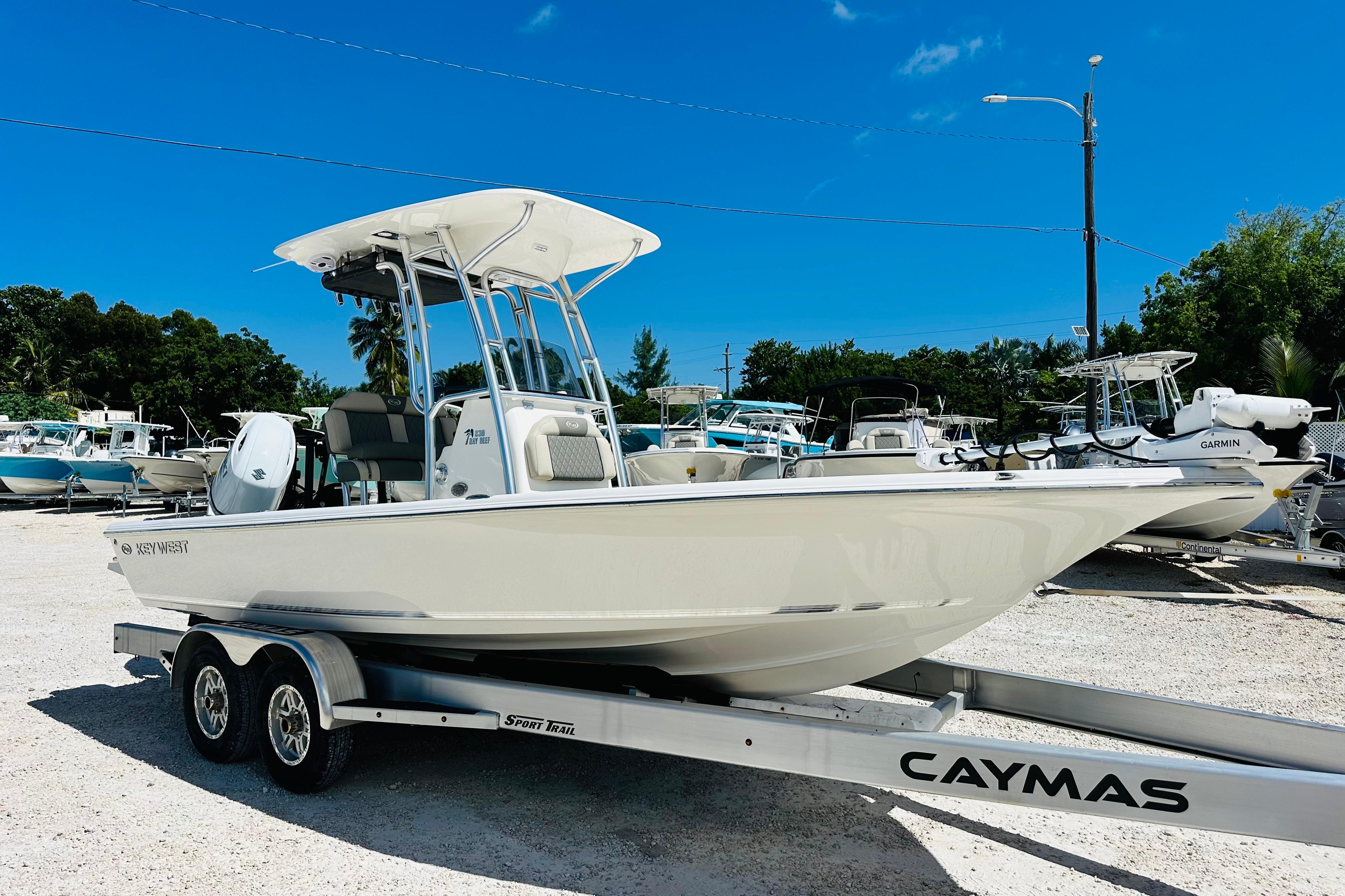 Key West 230 Bay Reef 2026 Key West 230 Bay Reef boat on trailer in sunny marina setting.