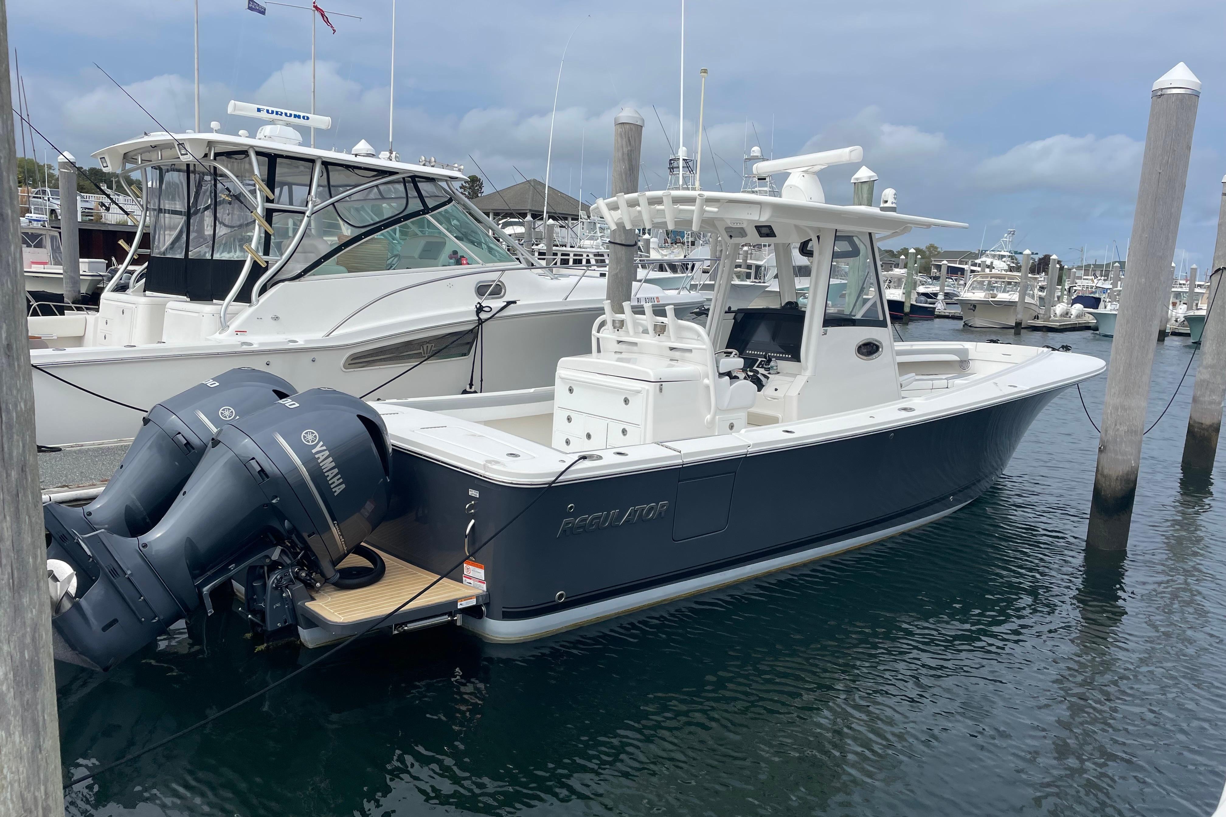 Regulator 31 2020 Regulator 31 boat docked with twin Yamaha engines.