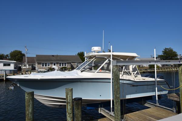 Grady-White Freedom 325 2019 Grady-White Freedom 325 boat docked at marina under clear blue sky.