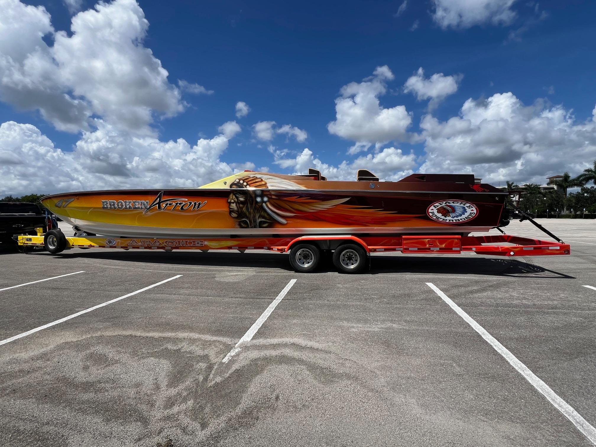 Apache 47 1991 Apache 47 powerboat "Broken Arrow" on trailer under blue sky.
