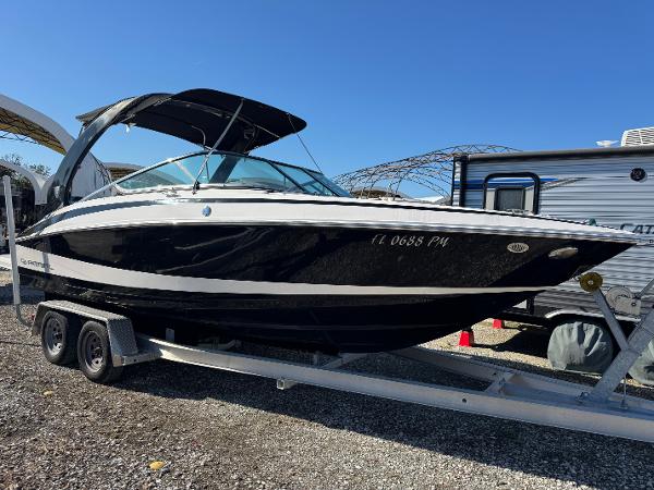 Regal 2500 Bowrider 2013 Regal 2500 Bowrider boat on trailer, black and white design, parked outdoors.