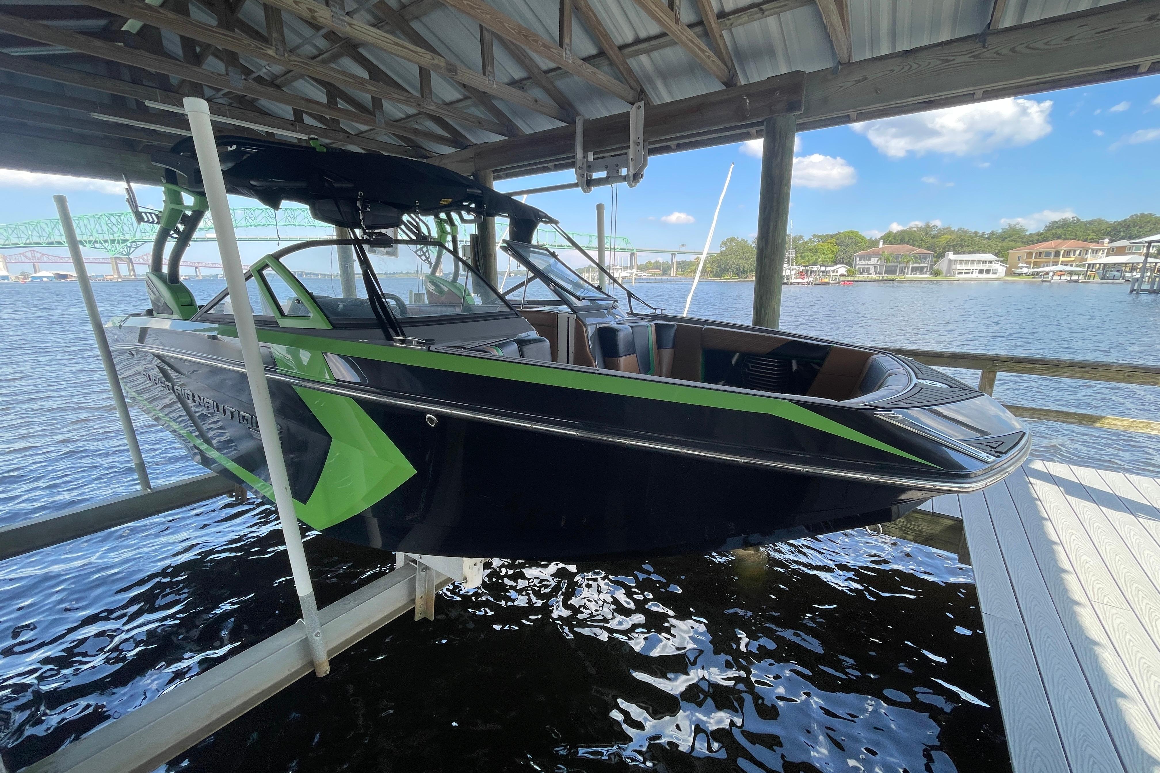 Nautique Super Air Nautique G23 Coastal Edition 2016 Nautique Super Air Nautique G23 Coastal Edition boat docked under a covered structure.
