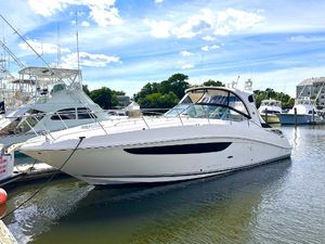 Sea Ray 370 Sundancer 2014 Sea Ray 370 Sundancer yacht docked at a marina on a sunny day.