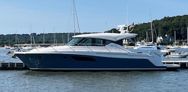 Tiara Yachts C44 Coupe 2018 Tiara Yachts C44 Coupe docked in a marina, surrounded by sailboats.