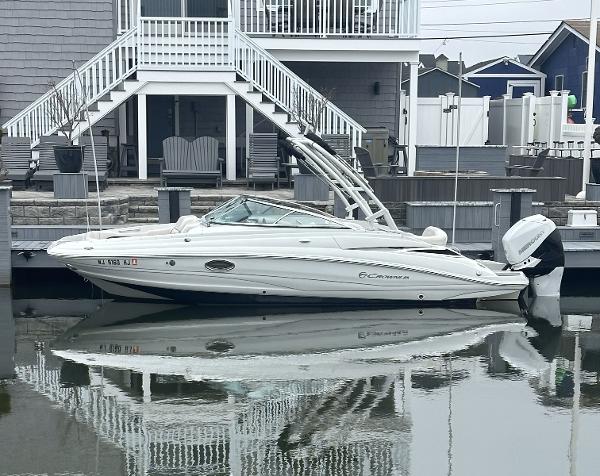 Crownline Eclipse E24 XS 2018 Crownline Eclipse E24 XS boat docked by a waterfront home.