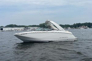 Regal FasDeck 2022 Regal FasDeck boat on a calm lake with marina in background.