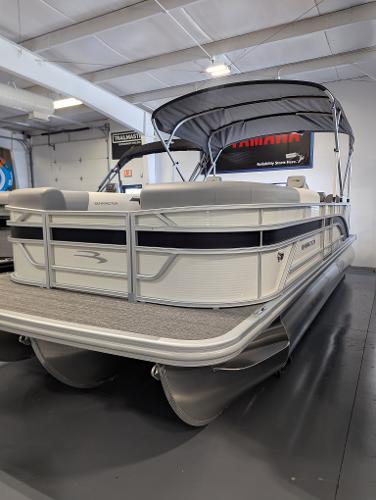 Bennington 22SSR 2024 Bennington 22SSR pontoon boat in showroom, featuring sleek design and canopy.