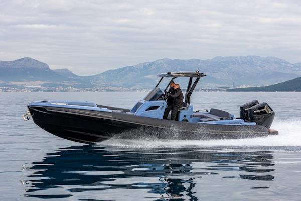 SuperRib Open 30 2025 SuperRib Open 30 speedboat cruising on calm water with mountainous backdrop.