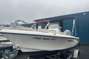 Key West 176 Center Console 2018 Key West 186 Center Console boat on trailer, parked near blue building.