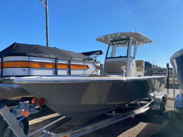 Sportsman Masters 247OE Bay Boat 2025 Sportsman Masters 247OE Bay Boat on trailer, displayed outdoors under clear blue sky.