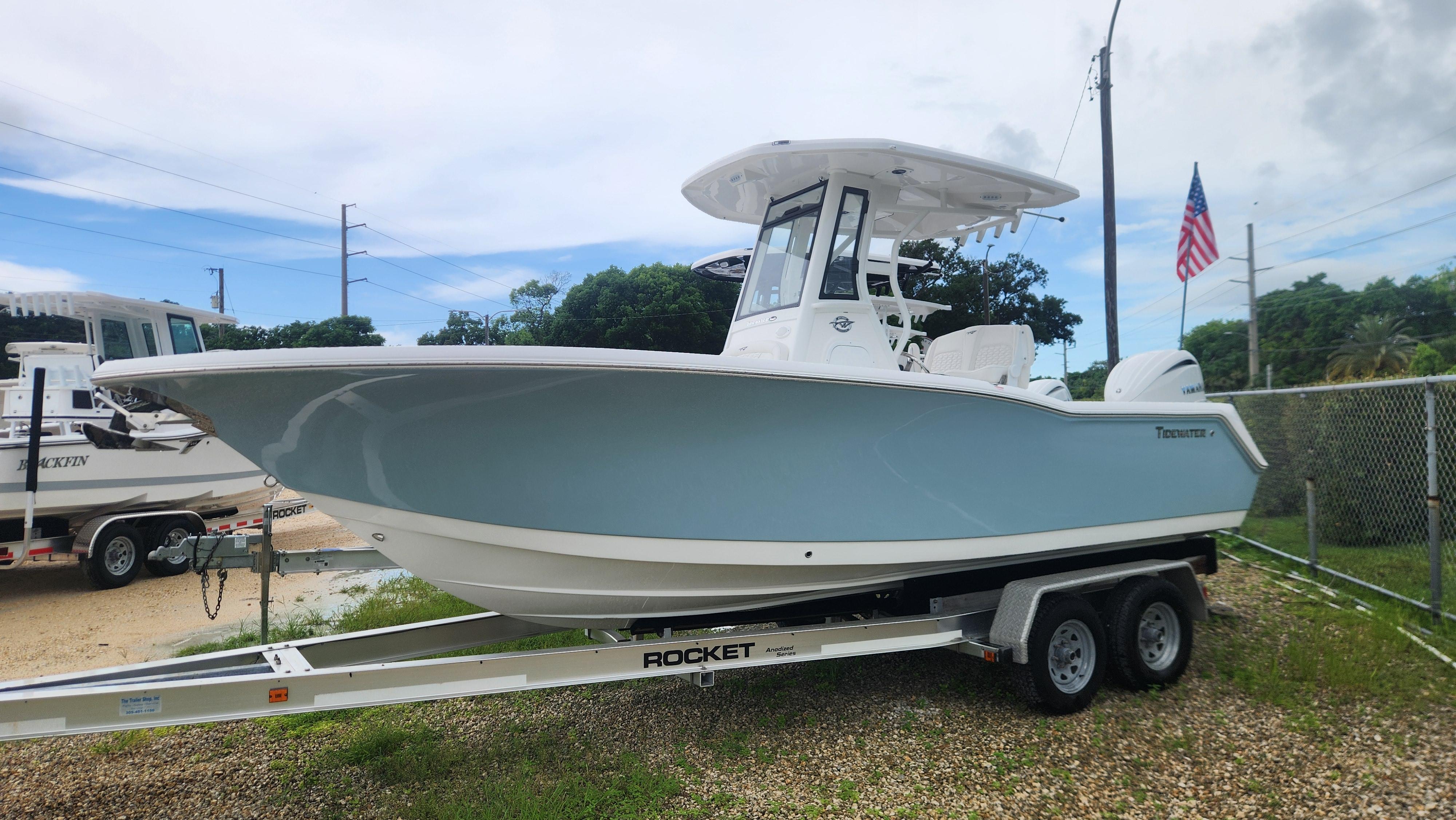 Tidewater 232 CC Adventure 2026 Tidewater 232 CC Adventure boat on trailer, parked outdoors with American flag.