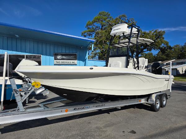 Ranger 2660 Bay 2025 Ranger 2660 Bay boat on trailer, parked outside a blue building.
