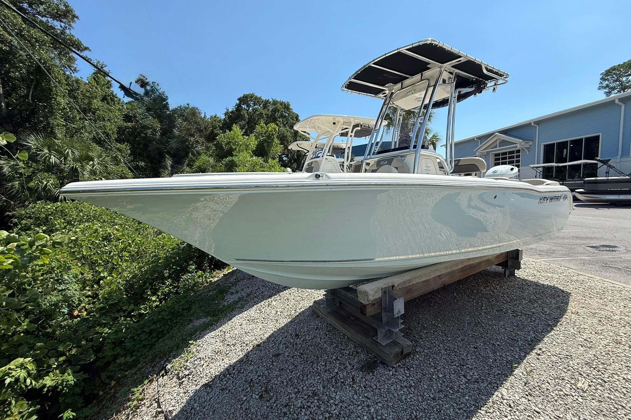 Key West 203 FS 2025 Key West 203 FS boat displayed outdoors on a gravel surface.