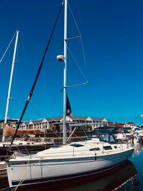 Hunter 33 Sailboat Hunter 33, 2008 model, docked at marina under clear blue sky.