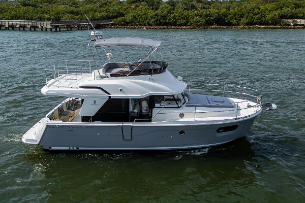 Beneteau Swift Trawler 35 2022 Beneteau Swift Trawler 35 cruising on a calm river.