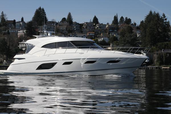 Riviera 6000 Sport Yacht 2016 Riviera 6000 Sport Yacht cruising on a calm lake with scenic background.