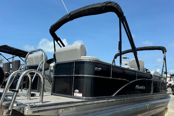 Manitou Oasis SR 2020 Manitou Oasis SR pontoon boat with black exterior and seating, under clear blue sky.