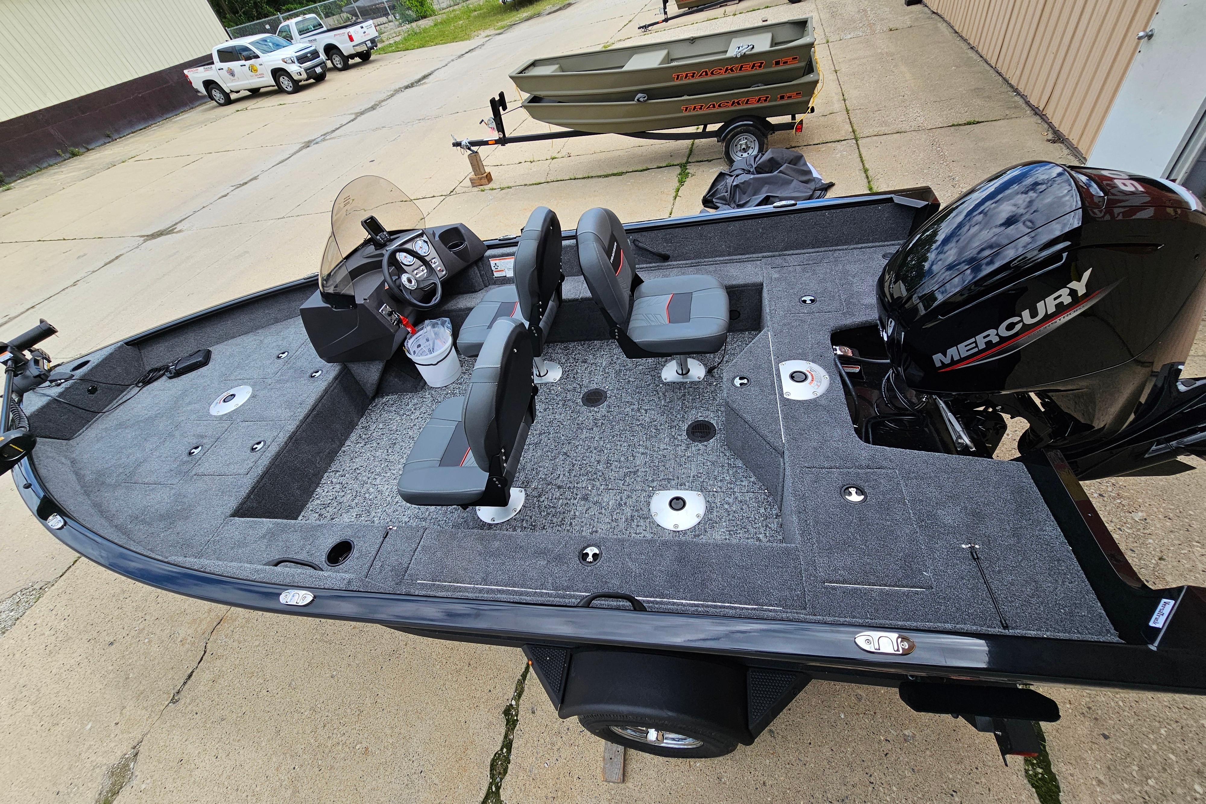 Tracker Pro Guide V-16 SC 2026 Tracker Pro Guide V-16 SC fishing boat with Mercury engine, parked outdoors.
