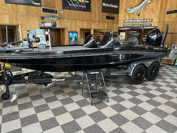 Triton 21XP Patriot 2024 Triton 21XP Patriot boat displayed indoors on checkered floor.